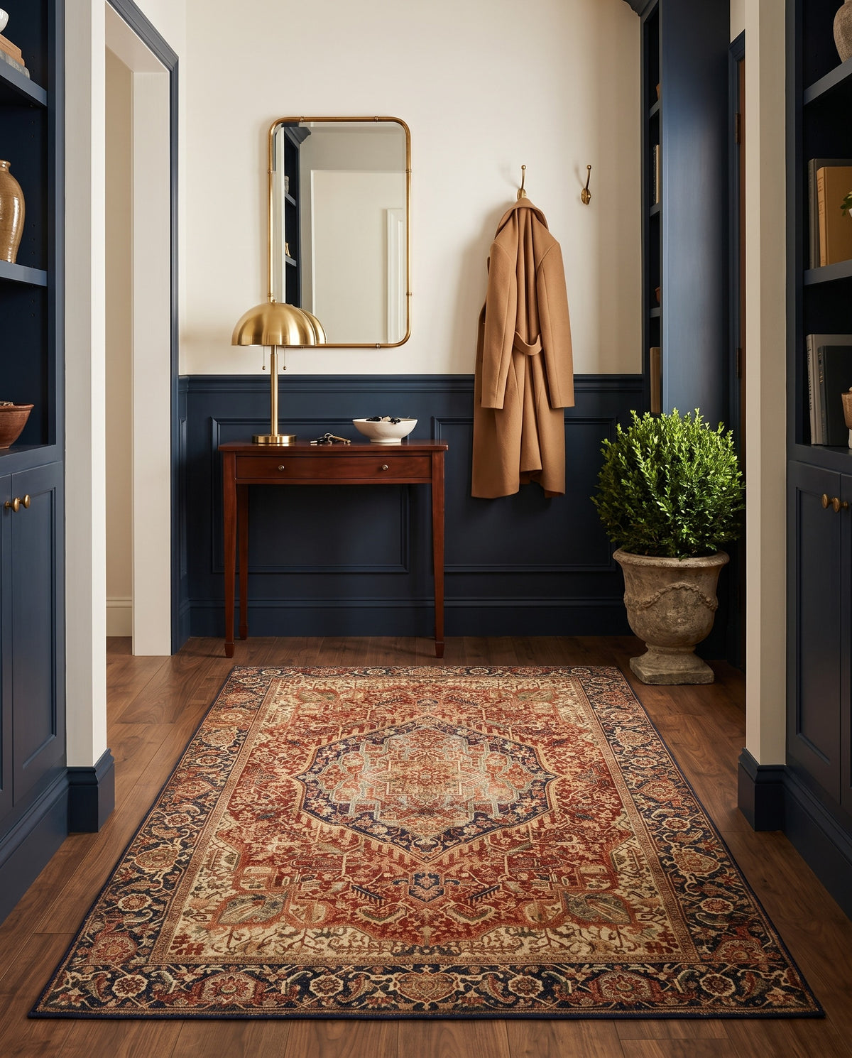 Azar Brick & Navy rug in an entryway with navy wainscoting and a mahogany console