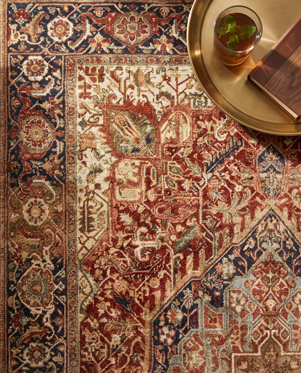 Close-up of the Azar rug medallion and navy border, soft low-pile velvet