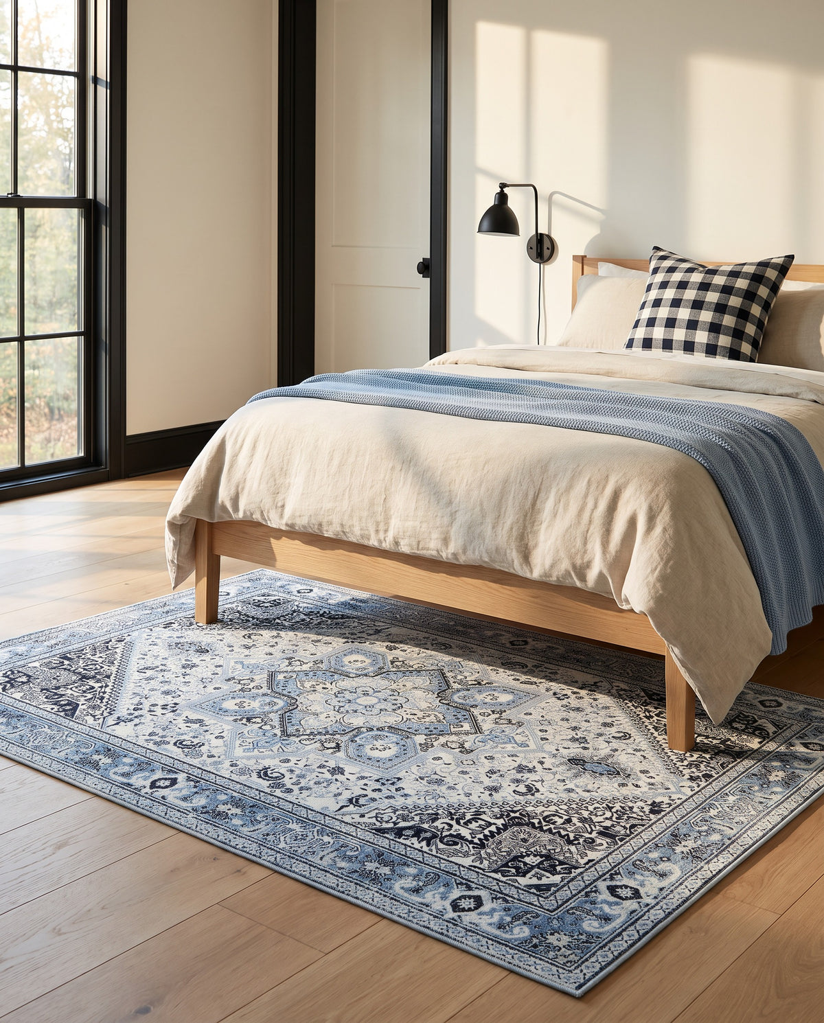 Darya Sky & Ink rug under a white oak bed in a bright bedroom