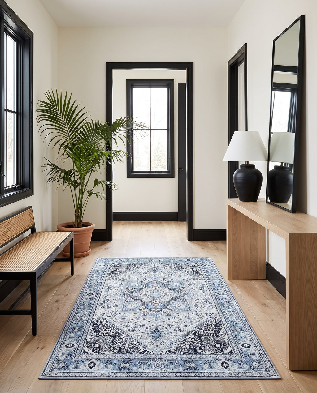 Darya Sky & Ink rug in a bright entryway with black window frames