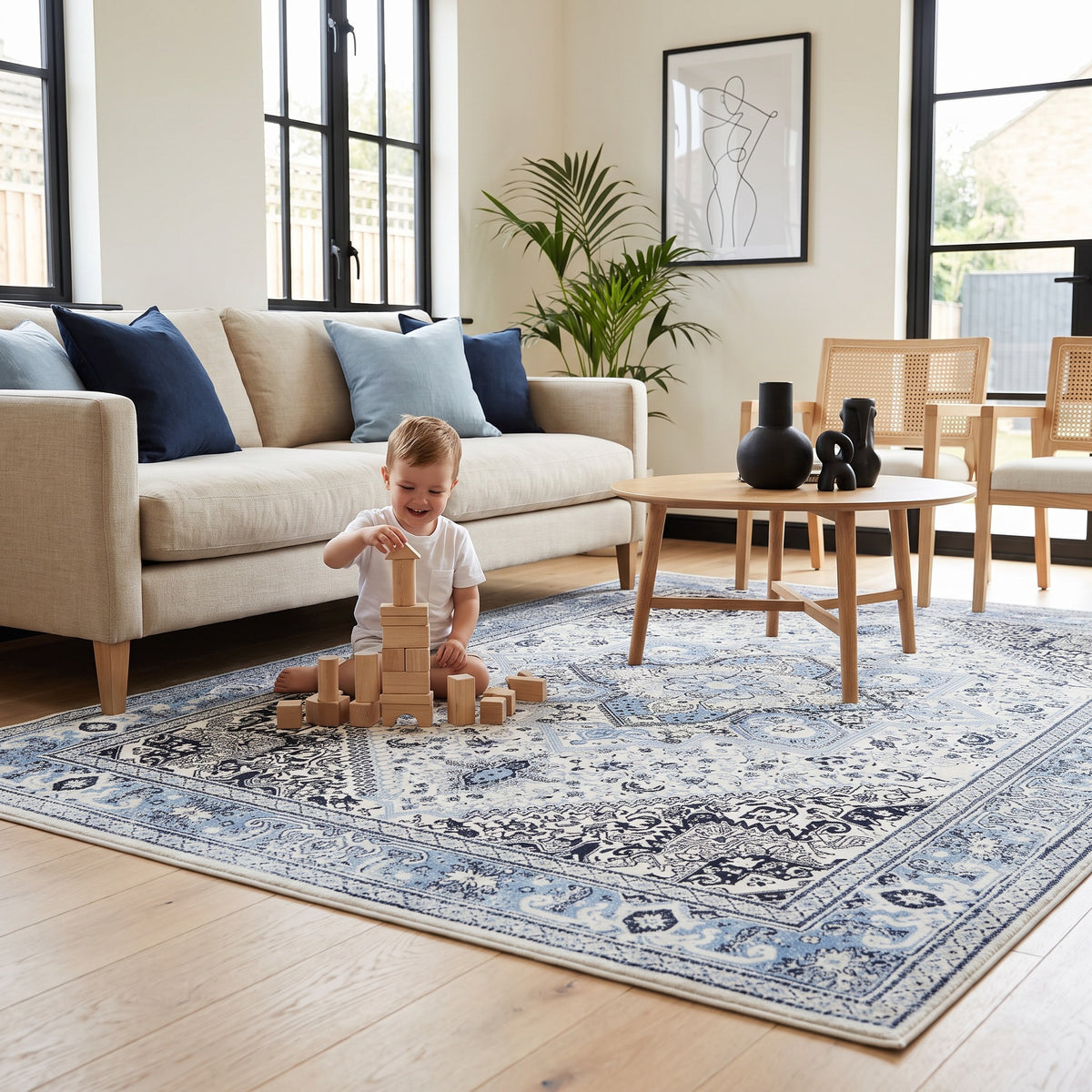 Child building a tower of wooden blocks on the Darya Sky & Ink rug