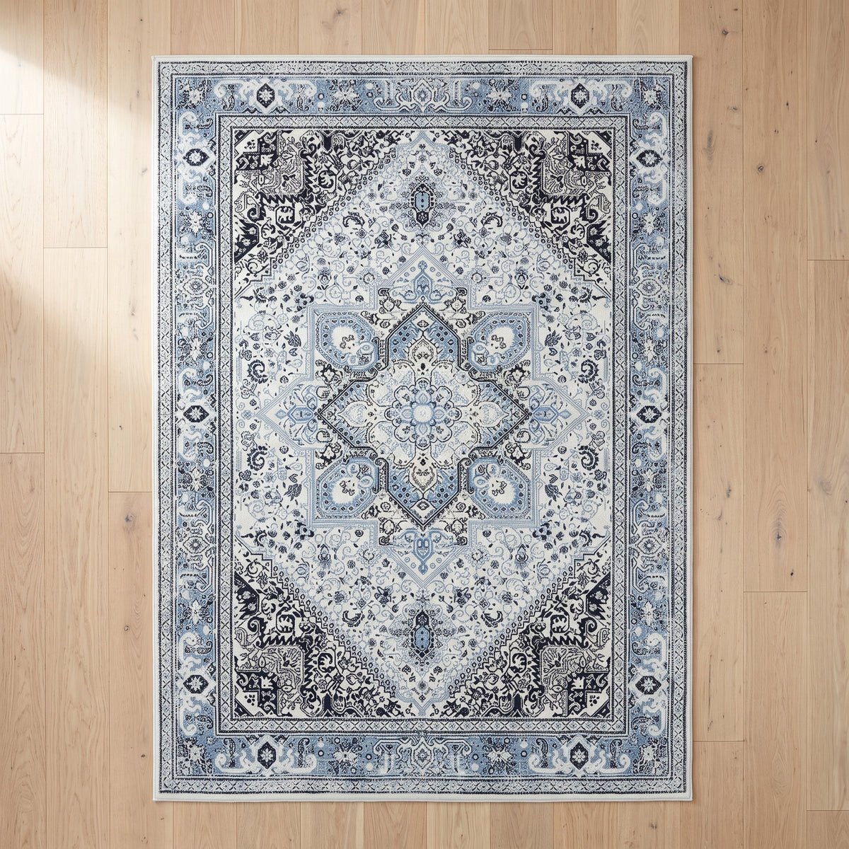 Darya Sky & Ink rug seen from above on a white oak floor