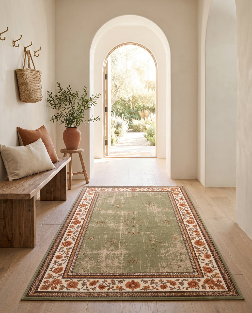 Golnar Sage & Saffron rug in an arched entryway with a wooden bench