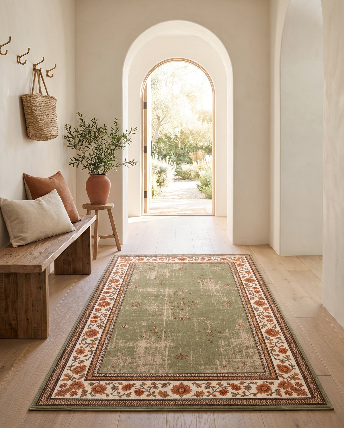 Golnar Sage & Saffron rug in an arched entryway with a wooden bench