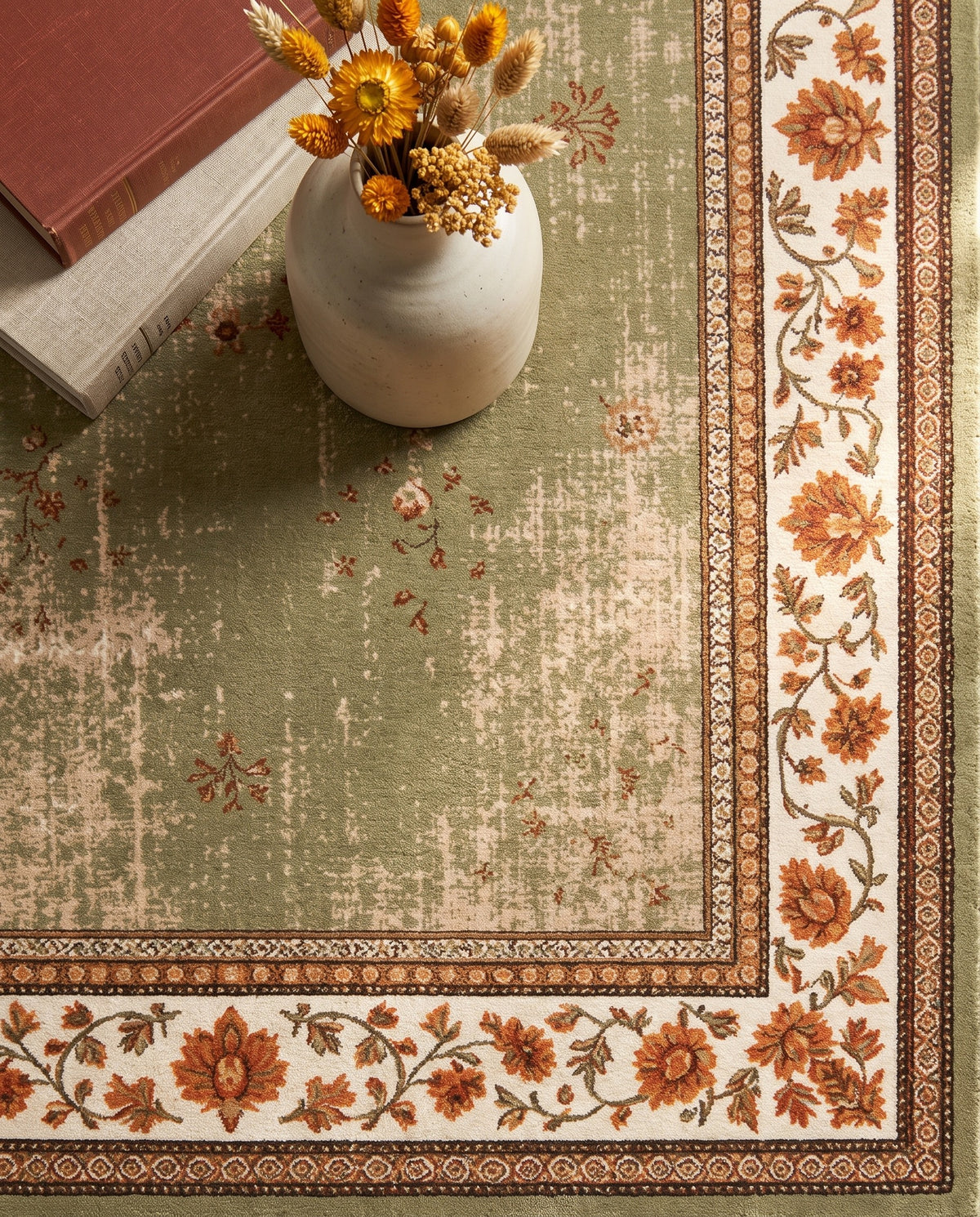 Close-up of the Golnar rug floral border and sage field, soft low-pile velvet