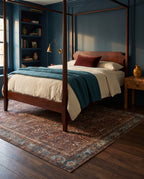 Kahroba Walnut & Teal rug under a mahogany four-poster bed with a teal wool blanket