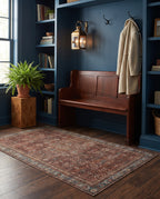 Kahroba Walnut & Teal rug in a deep blue entryway with a mahogany bench