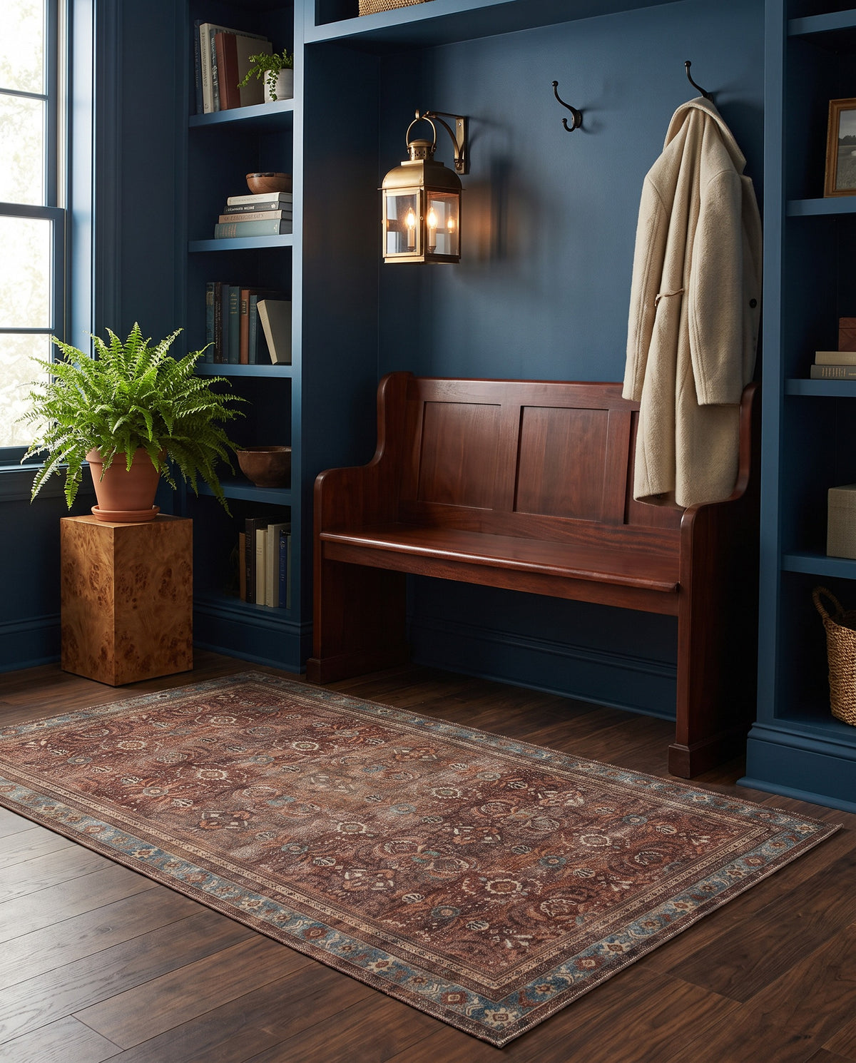 Kahroba Walnut & Teal rug in a deep blue entryway with a mahogany bench