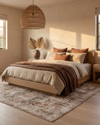 Kavir Sand & Cocoa rug under a bleached oak platform bed in a sunlit bedroom