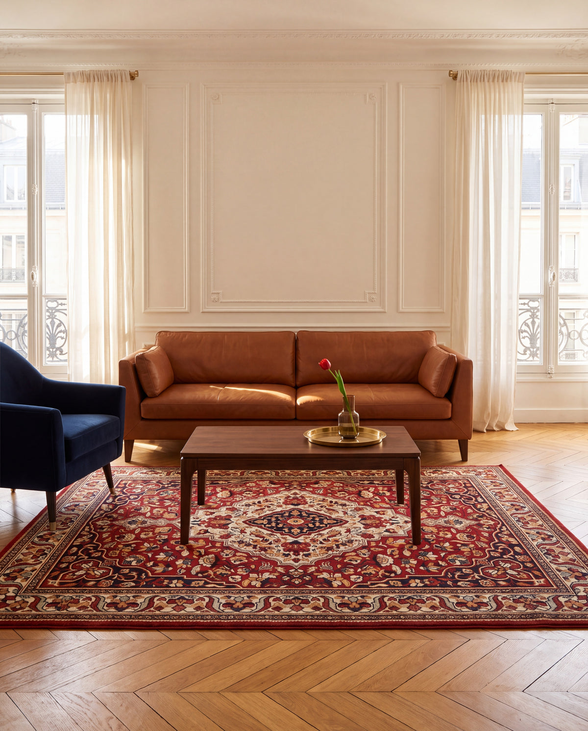 Laleh Garnet & Cream rug in a Parisian living room with a cognac leather sofa