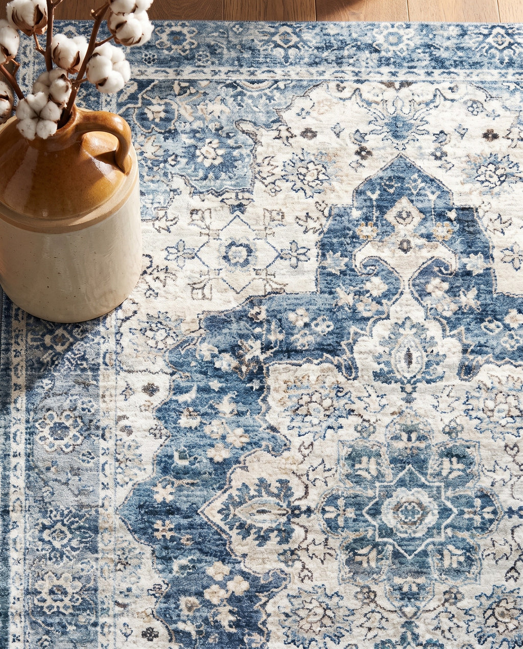 Close-up of the Mahtab rug denim-blue medallion and border, soft low-pile velvet
