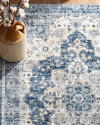 Close-up of the Mahtab rug denim-blue medallion and border, soft low-pile velvet