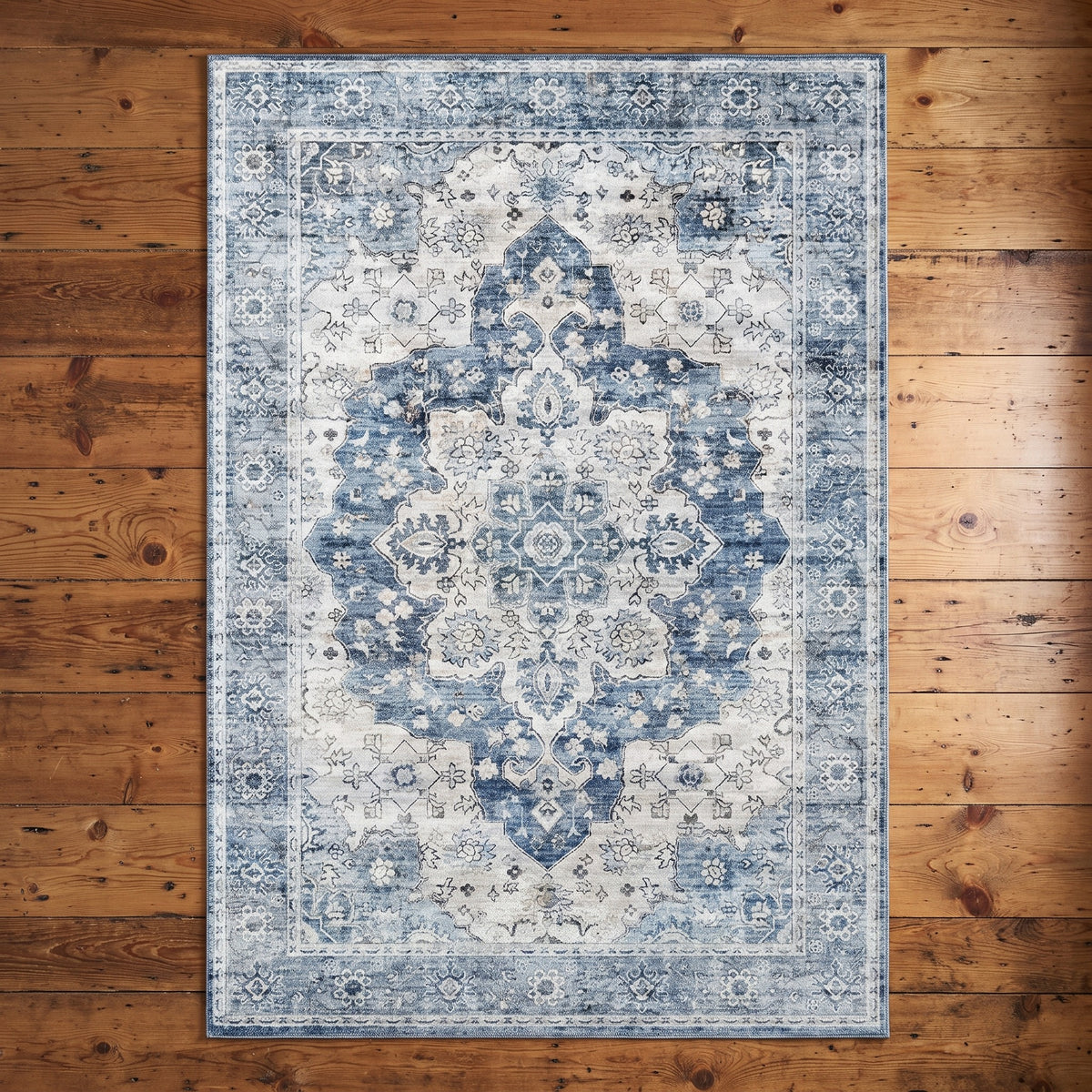 Mahtab Denim & Cream rug seen from above on a knotty pine floor