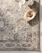 Close-up of the Morvarid rug soft grey medallion and border, soft low-pile velvet