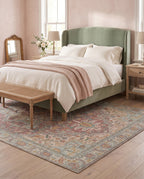 Nasrin Rose & Sage rug under a sage velvet bed in a romantic bedroom