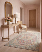 Nasrin Rose & Sage rug in a pink plaster entryway with an antique gold mirror