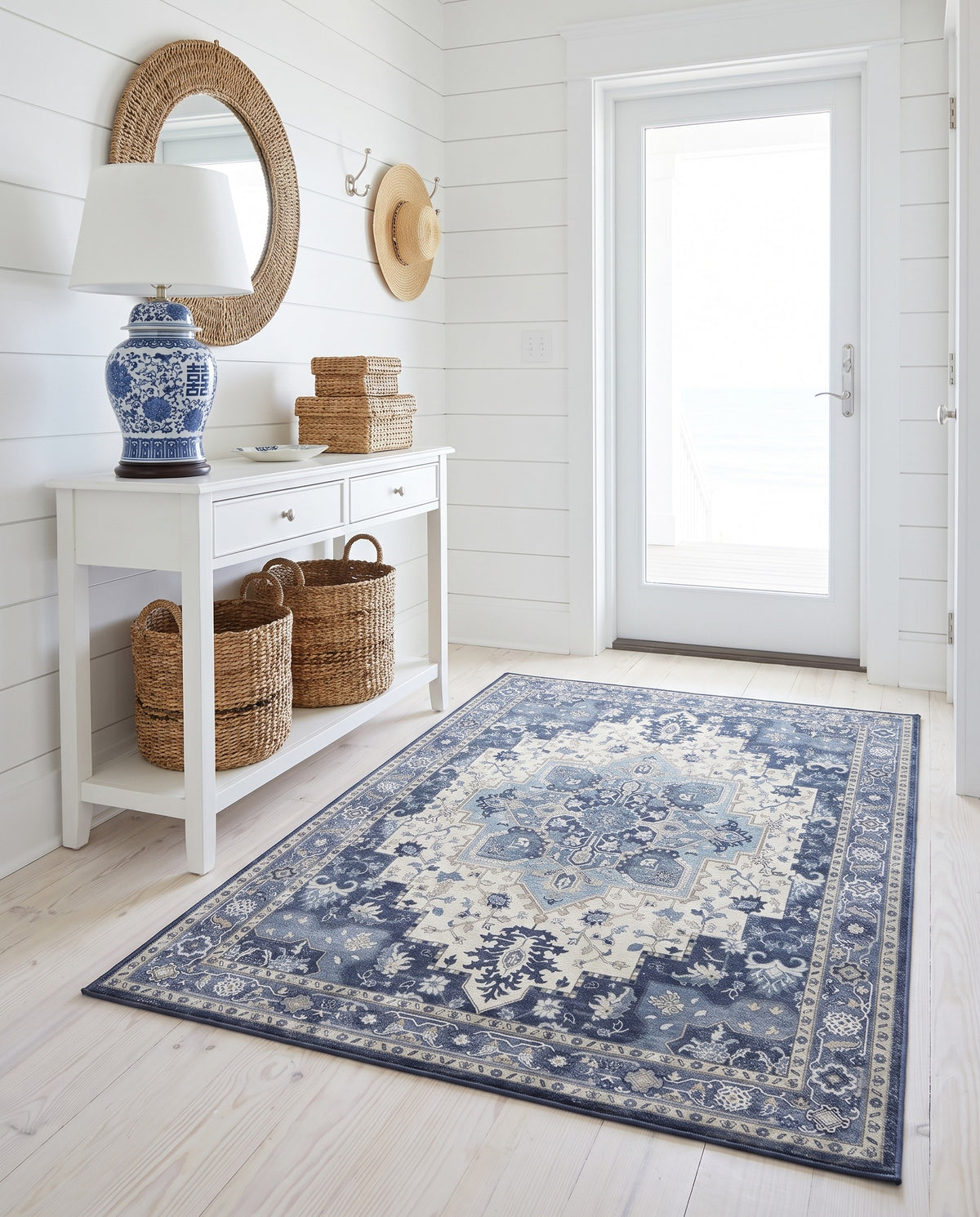 Nilufar Indigo & Ivory rug in a white shiplap entryway with a blue and white lamp