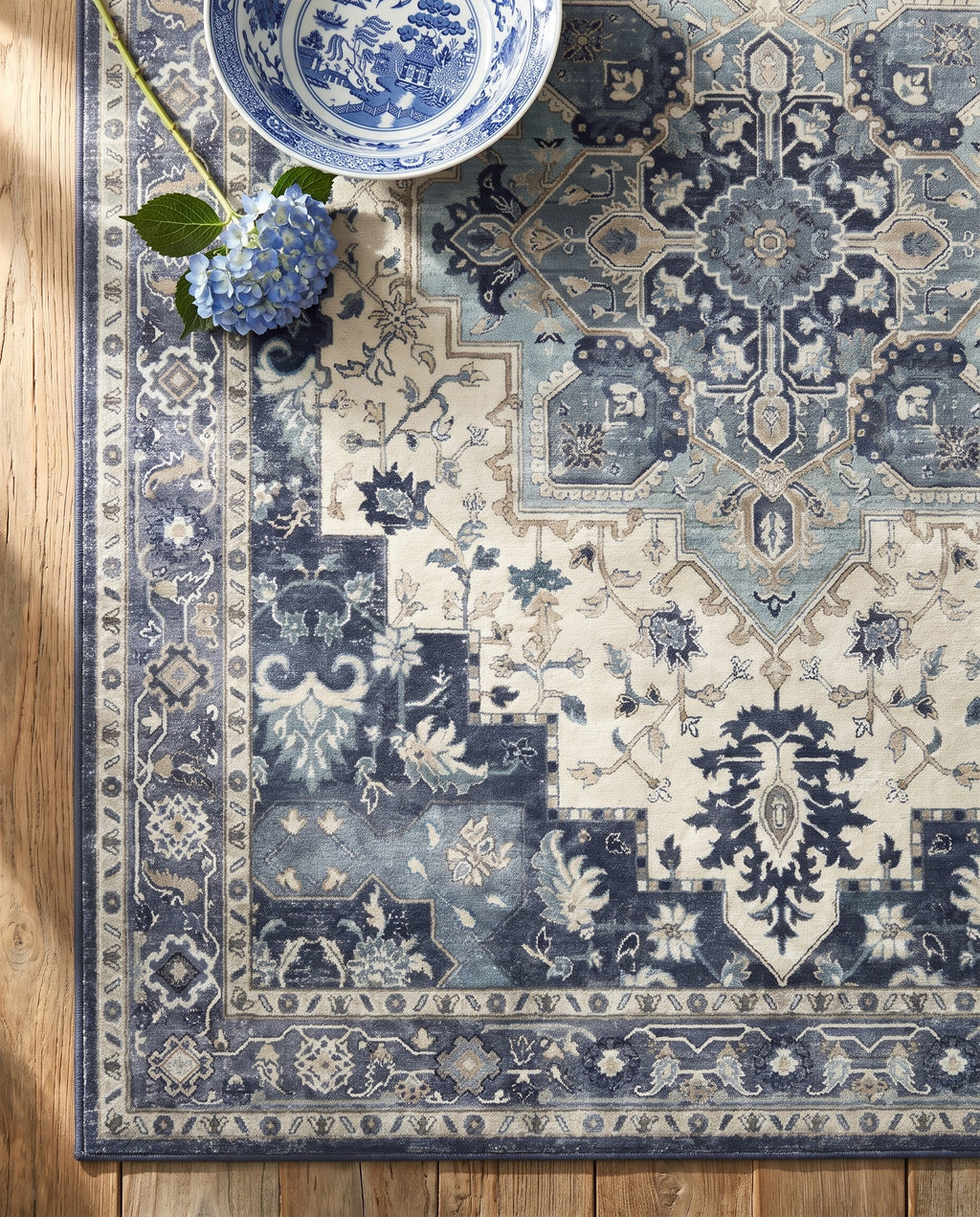 Close-up of the Nilufar rug indigo medallion and border, soft low-pile velvet