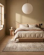 Pardis Oat & Clay rug under a low ash platform bed in a Japandi bedroom