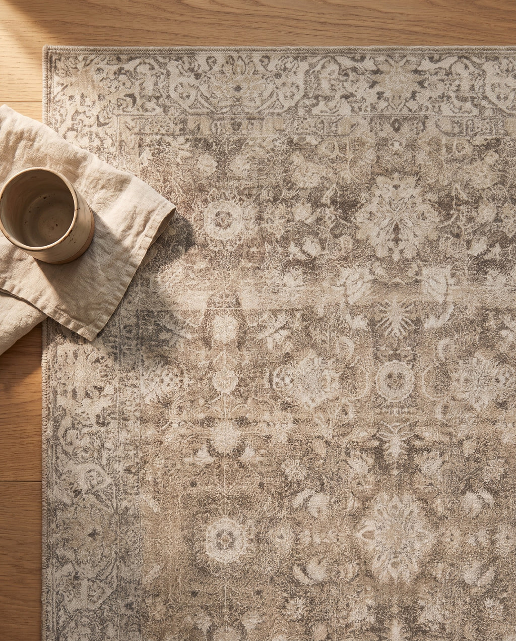 Close-up of the Pardis rug oat field and faded clay pattern, soft low-pile velvet