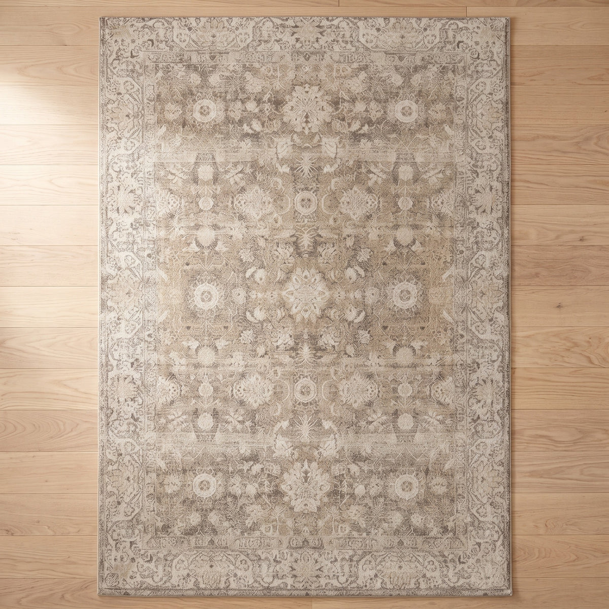 Pardis Oat & Clay rug seen from above on a natural ash floor