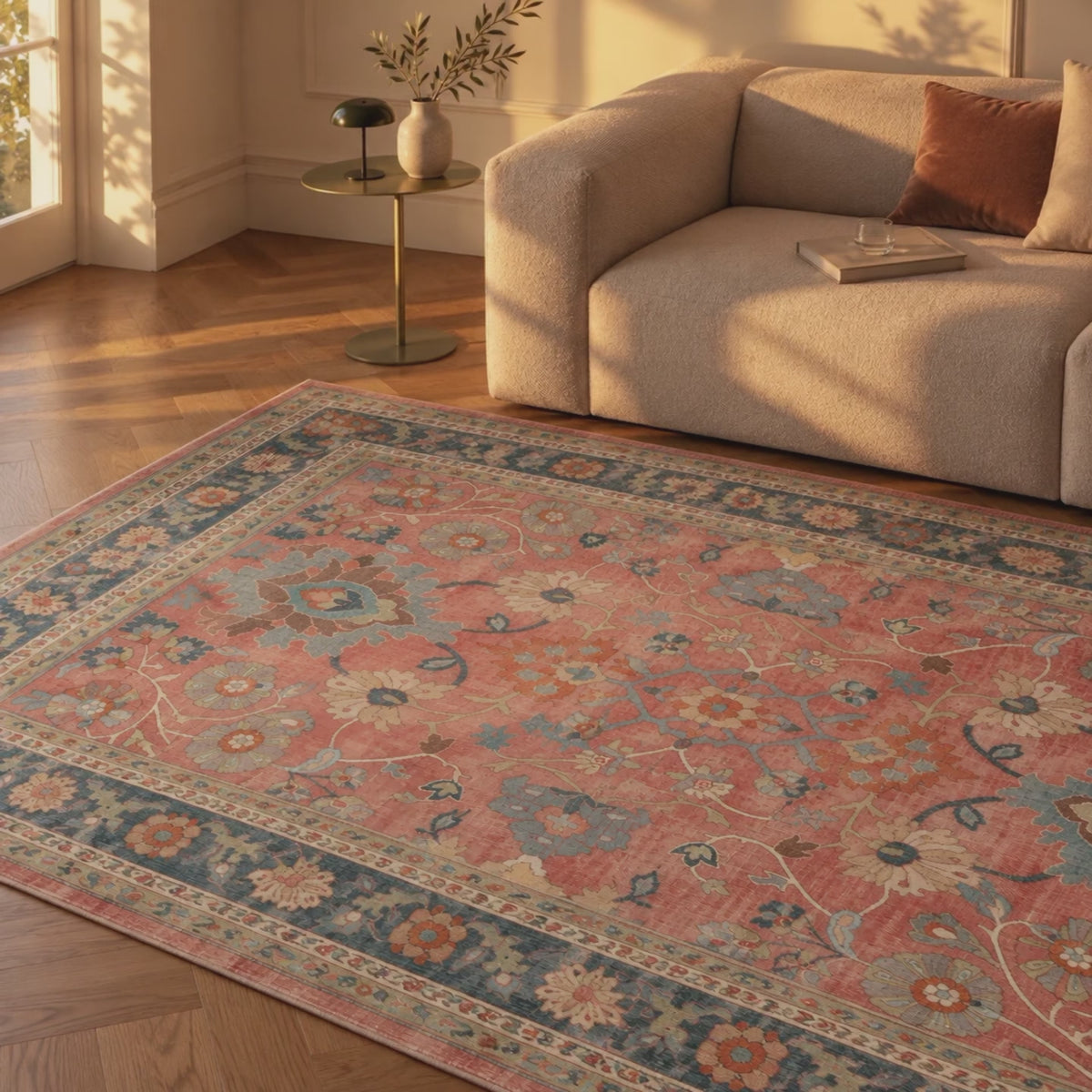 Sunlight moving across a coral and blue Persian-style rug beside a beige sofa