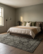 Shabnam Charcoal & Olive rug under a smoked-oak bed in a cocooning bedroom