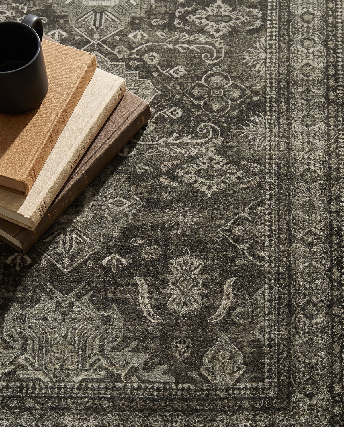 Close-up of the Shabnam rug border and charcoal field, soft low-pile velvet