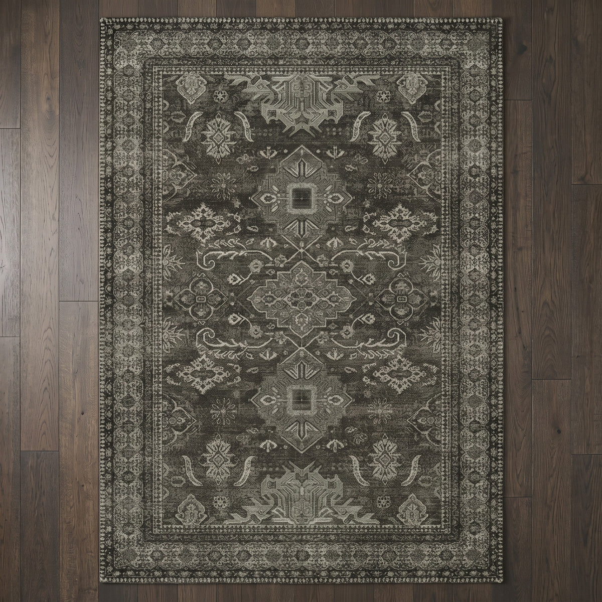 Shabnam Charcoal & Olive rug seen from above on a smoked oak floor