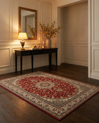 Shahrzad Crimson & Navy rug in a candlelit entryway with a gilded mirror
