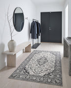 Simin Ash & Ivory rug in a bright minimalist entryway with a pale ash bench