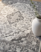 Close-up of the Simin rug ash-grey medallion and border, soft low-pile velvet