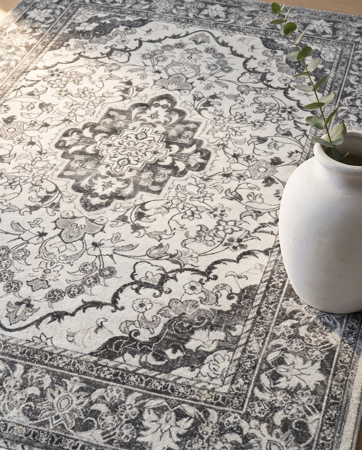 Close-up of the Simin rug ash-grey medallion and border, soft low-pile velvet