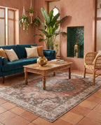 Soraya Terracotta & Teal rug in a riad-style living room with a deep teal velvet sofa