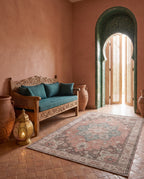 Soraya Terracotta & Teal rug in a riad entryway with a tiled arch and carved bench