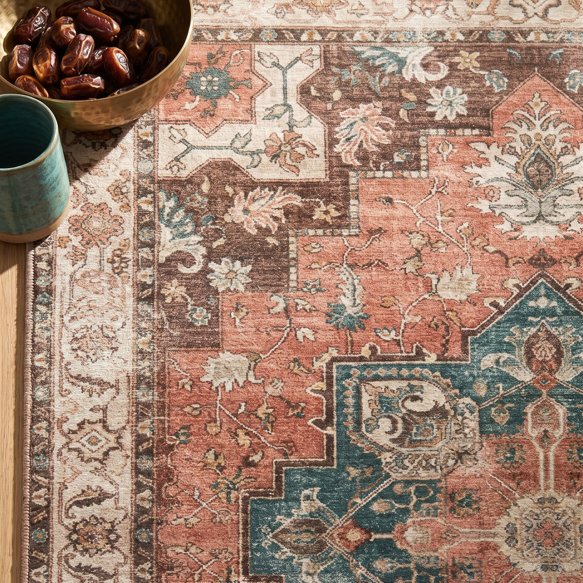 Soraya rug corner with a brass bowl of dates and a teal cup