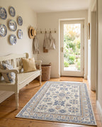 Yasaman Ivory & Cornflower rug in a cottage entryway with blue and white plates