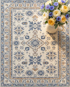 Close-up of the Yasaman rug cornflower motifs and border, soft low-pile velvet